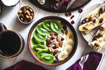 Yogurt with different fruits on a wooden background. Useful food, diet, organic.