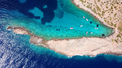 Aerial photo of tropical rocky seascape with beutiful turquoise clear sea and boats docked
