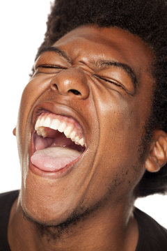 Very happy african american young man with funny face on white background