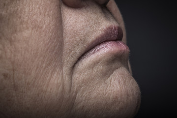 Obraz premium Studio portrait of elderly woman. Profile. Close up detail. Toned