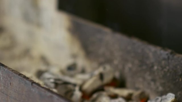 Close-up of taking metal skewers with roasted golden brown lula kebab from hot grill
