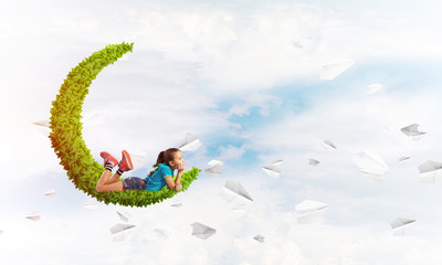 Concept of careless happy childhood with girl dreaming about something