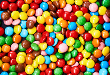 Fototapeta na wymiar Small colorful candy on a black background. 