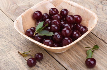 Ripe sweet cherries on a wooden background