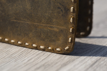 Stylish leather wallets in box on wooden background