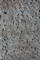 Grey concrete background with small holes and scratches. Abstract cement texture.