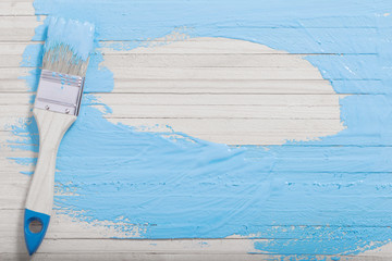 brush with paint on wooden background
