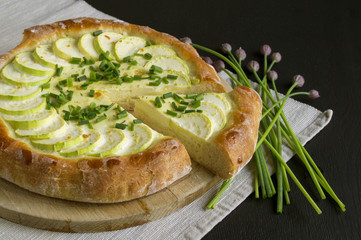 Homemade rustic pie with zucchini and onions.