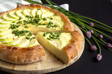 Homemade rustic pie with zucchini and onions.