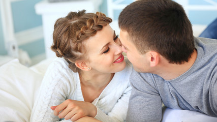 Happy couple on the sofa bed in the living room.