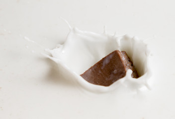 Chocolate falls in milk