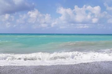 Fototapeta na wymiar The sea of beautiful mint color, waves and sea foam.