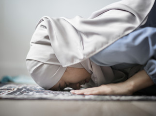 Muslim woman praying in Sujud posture