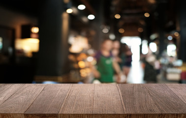 Empty dark wooden table in front of abstract blurred bokeh background of restaurant . can be used for display or montage your products.Mock up for space.