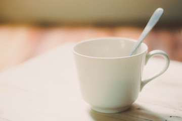 Coffee cup with hot coffee on old wood