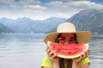 girl with straw hat sunglasses and watermelon on summer vacation