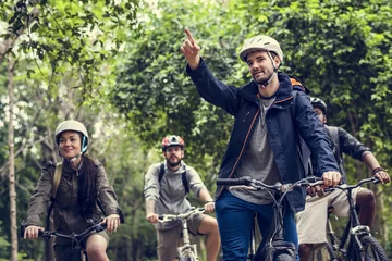 Tuinposter Group of friends ride mountain bike in the forest together © Rawpixel.com