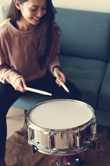 White woman playing drum