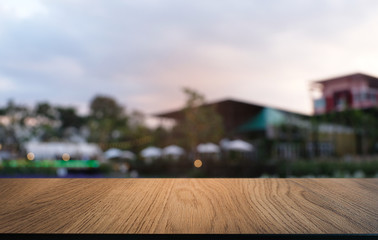 Empty dark wooden table in front of abstract blurred bokeh background of restaurant . can be used for display or montage your products.Mock up for space.