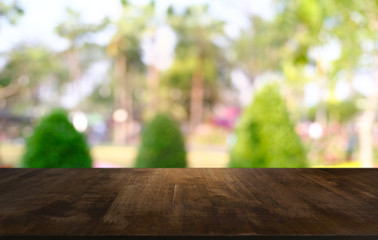 Empty dark wooden table in front of abstract blurred bokeh background of restaurant . can be used for display or montage your products.Mock up for space.