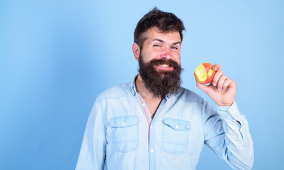 I love apples! Man handsome hipster with long beard eating apple. Hipster hungry bites enjoy ripe apple. Fruit healthy snack always good idea. Man diet nutrition eats fruit. Healthy nutrition concept