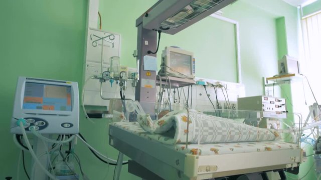 Newborn baby in a hospital room.