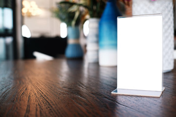 Menu frame standing on wood table in Bar restaurant cafe. space for text marketing promotion.