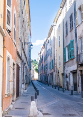 Fototapeta na wymiar colorful houses on narrow street Grande Rue in Draguignan, Cote d'Azur, France on sunny summer day