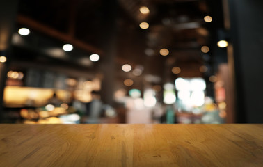Empty dark wooden table in front of abstract blurred bokeh background of restaurant . can be used for display or montage your products.Mock up for space.