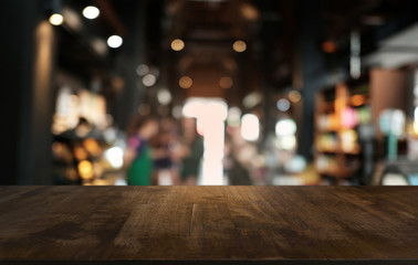 Empty dark wooden table in front of abstract blurred bokeh background of restaurant . can be used for display or montage your products.Mock up for space.