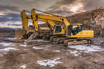 Heavy machinery in a hard day of work in the construction of a road