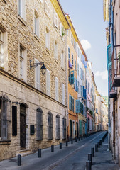 colorful houses on narrow street Grande Rue in Draguignan, Cote d'Azur, France on sunny summer day