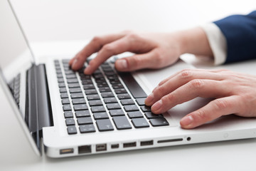 Close Up of businessman hands using laptop computer