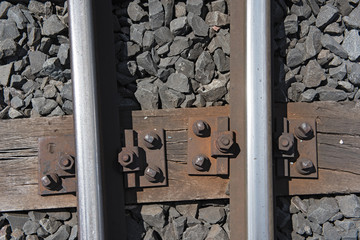Rails on the wooden sleepers with basalt stone as a substructure