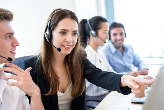 Businesswoman telemarketing staff working with coworker in call center office