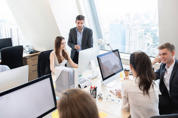 Group of business people working in high rise office buiding in the city © Atstock Productions