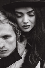 A beautiful couple on a black background is full of emotions