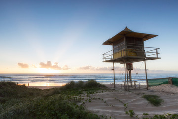 Fototapeta premium Lifeguard patrol tower on the beach at sunrise, Gold Coast Australia