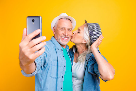 Modern device gadget in hand internet connection instagram concept. Close up photo portrait of romantic cute lovely nice glad beautiful lady giving kiss to gentleman isolated on vivid background