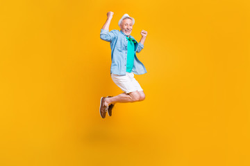 Fototapeta na wymiar Freedom fly happiness hipster white jeans shorts stylish modern green outfit concept. Full length size photo portrait of joyful rejoicing handsome laughing cheerful guy jumping up isolated background