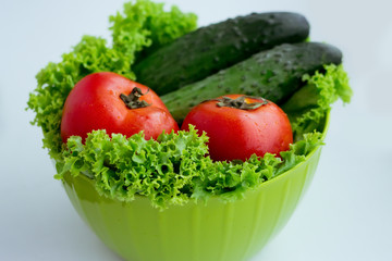 Fresh red tomatoes, green salad and cucumber