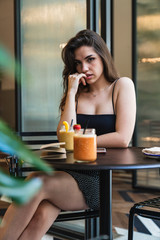 Sensual woman sitting in cafe