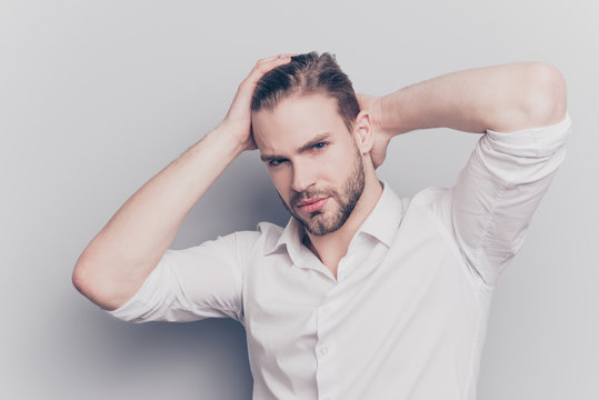 Half-turned portrait of sexy handsome attractive stunning unshaven entrepreneur trying to fix correct his hair with hands palms isolated on gray background rolled up sleeves copy-space