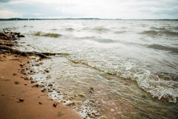 Soft wave of the blue sea on a sandy beach.