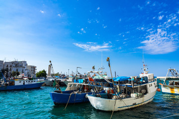 Fototapeta na wymiar Fishing boats ready to sail from Monopoli port. Monopoli, Apulia, Italy, August 2017