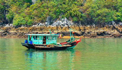 Fototapeta na wymiar A fishing boat in the bay, Halong, Vietnam. Copy space for text.