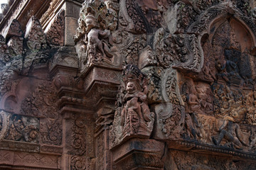 Fototapeta na wymiar Angkor Cambodia, carvings of garuda and east facing pediment with Siva seated on the summit of Mount Kailasa on southern library at the 10th century Banteay Srei temple