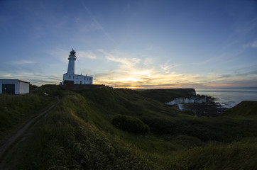 Fototapeta na wymiar Coastal Landscape with Lighthouse at Sunset