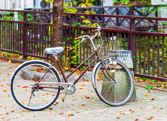 Fototapeta na wymiar Brown bicycle on the city street, Kyoto in Japan. Copy space for text.