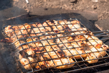 meat chicken wings roasted in the grill grill on the coals in the courtyard of the house